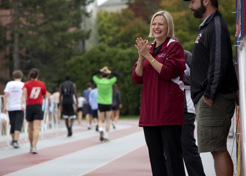 Christine Reif cheers on the runners as they finish the race.