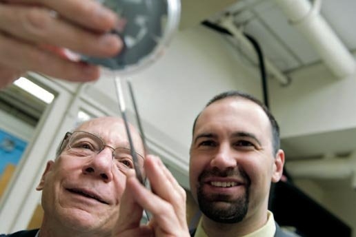 Joel Schindall of electrical engineering and computer science (left) and Riccardo Signorelli PhD ’09 of FastCAP Systems examine carbon-nanotube-coated samples that proved key to the development of the full-scale, high-performance ultracapacitors now being marketed by FastCAP.