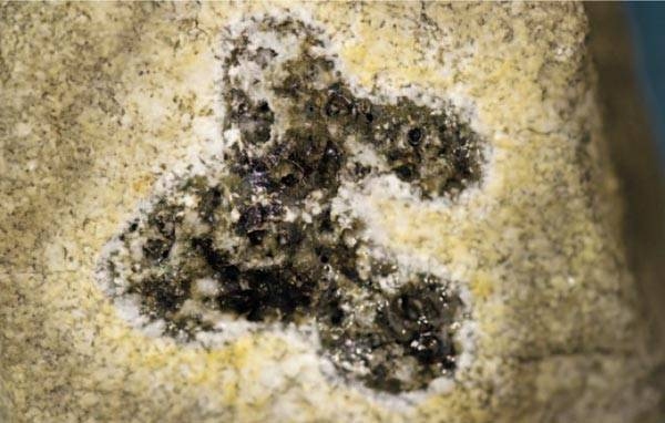 The dark pattern on this granite sample shows where the beam hit the rock, causing it to bubble and vaporize. The new setup enabled the team not only to vaporize rock for the first time but also to take real-time measurements that provided new insights into key thermodynamic properties of rock up to extremely high temperatures.