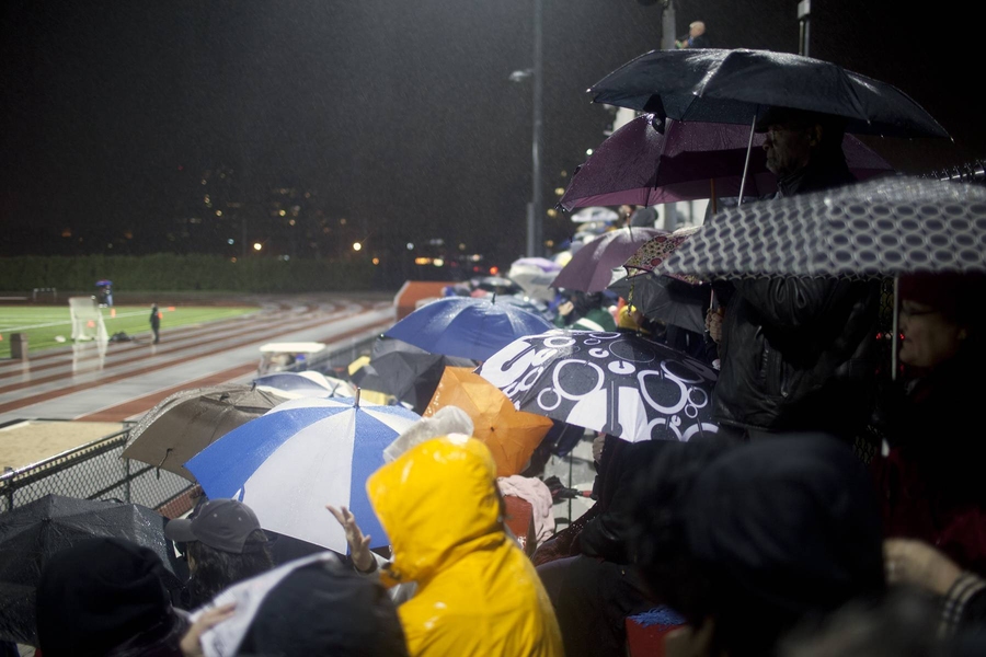 The rain did not keep away fans of both teams — although there were almost as many umbrellas in the stands as there were fans.