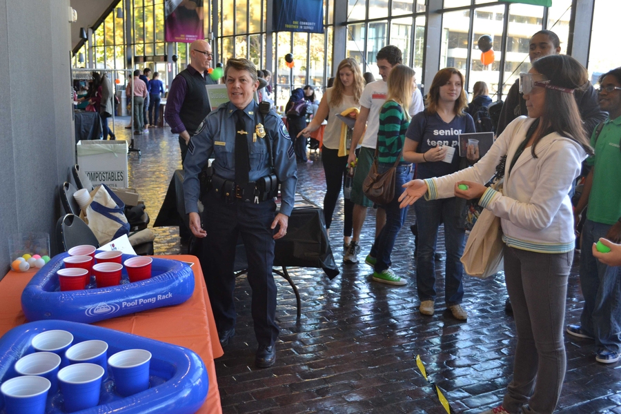 Of the nearly 20 organizations and departments represented at the MIT Wellness Fair, several featured fun giveaways or activities for students. In this photograph, Maiko Kitaoka &#39;16 visited the MIT Police table where Sgt. Cheryl Vossmer spoke about alcohol awareness and safety.