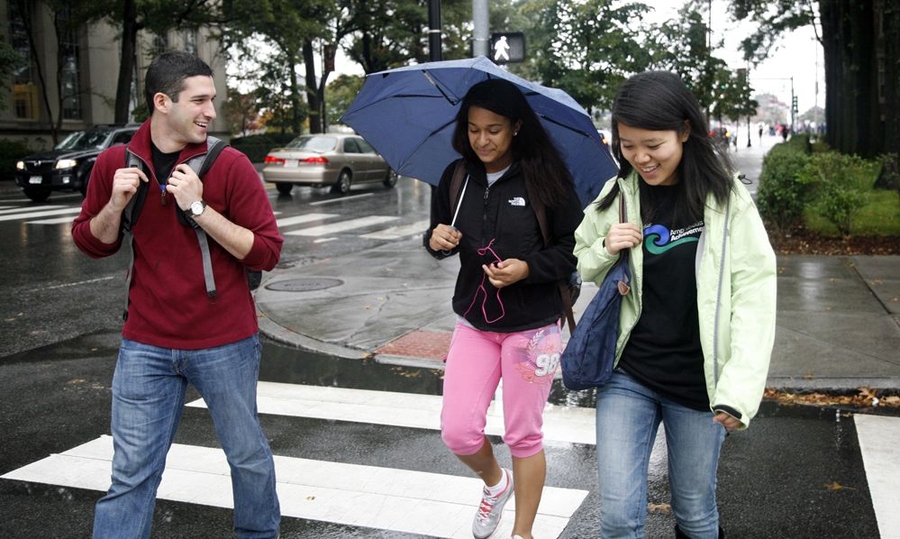 Amphibious Achievers' coaches Angrist and Jess Shi, right, walk with Genesis Villar, middle, from the MIT boathouse, after an intense rowing workout, to the academic classroom in Building 56.