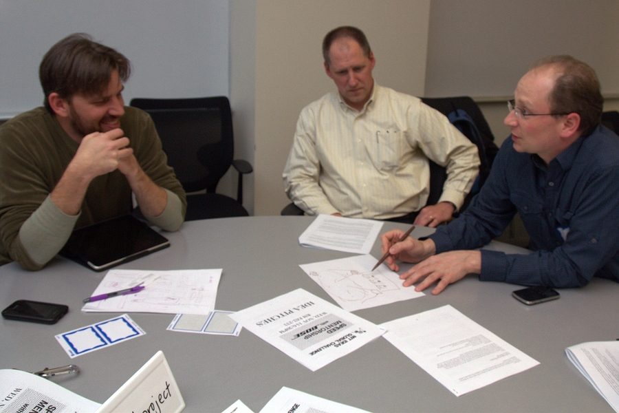 Lee Zamir MEng '96 (right), director of the Bose Corporation's New Business Development Lab, sketches out an idea for Jason Hill (left) of the BETH Project. A 2012 MIT IDEAS Global Challenge winner, the BETH Project aims to develop a new prosthetic sock to help amputees self-adjust their prosthetic as needed.