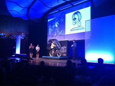 The 'outdoors' was the theme of this year's competition in the 2.009 Product Engineering Processes course. Here, a team demonstrates its plastic and fabric canopy designed to shield a bicyclist from rain.