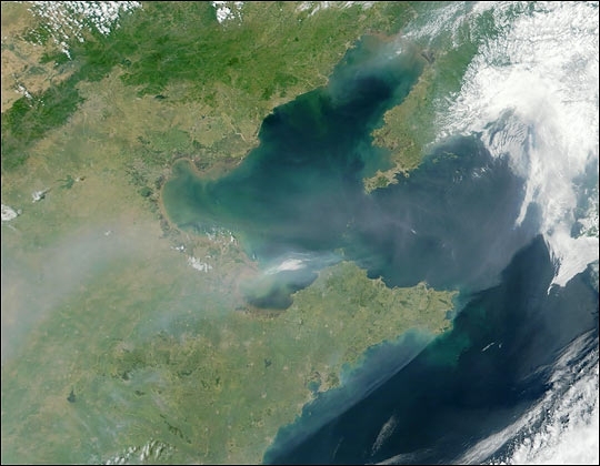 Satellite image of a thick plume of aerosol pollution over eastern China, extending eastward over Bo Hai Bay and Korea Bay.