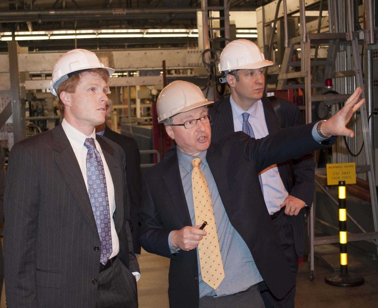 Earl Marmar, head of the Alcator project, introduces Kennedy to MIT's tokamak, accompanied by David Belluck of Riverside Partners.