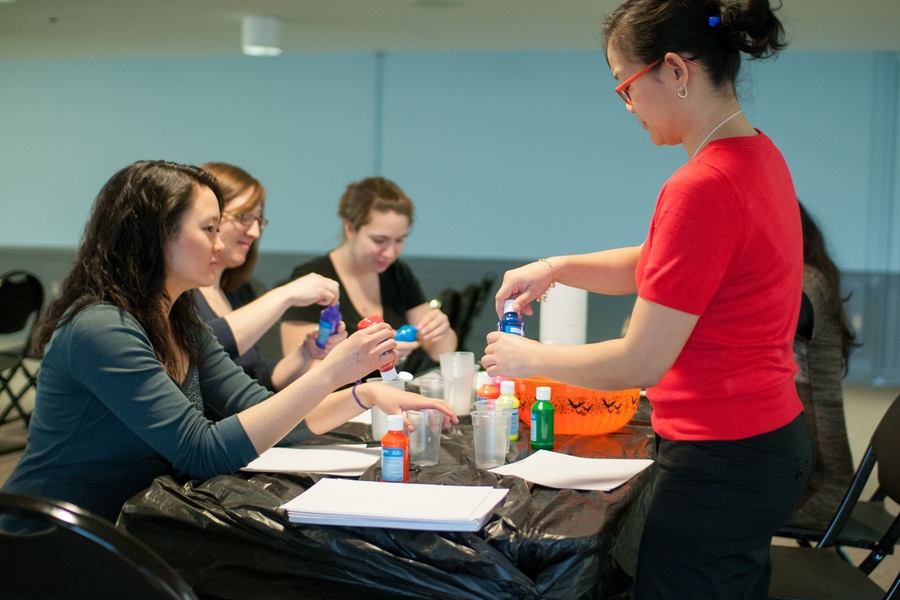 Students selected their paint colors as part of the “Finger Paint your Stress Away” class, taught by Crystal Eusebio (right), a graduate intern in the Student Activities Office.