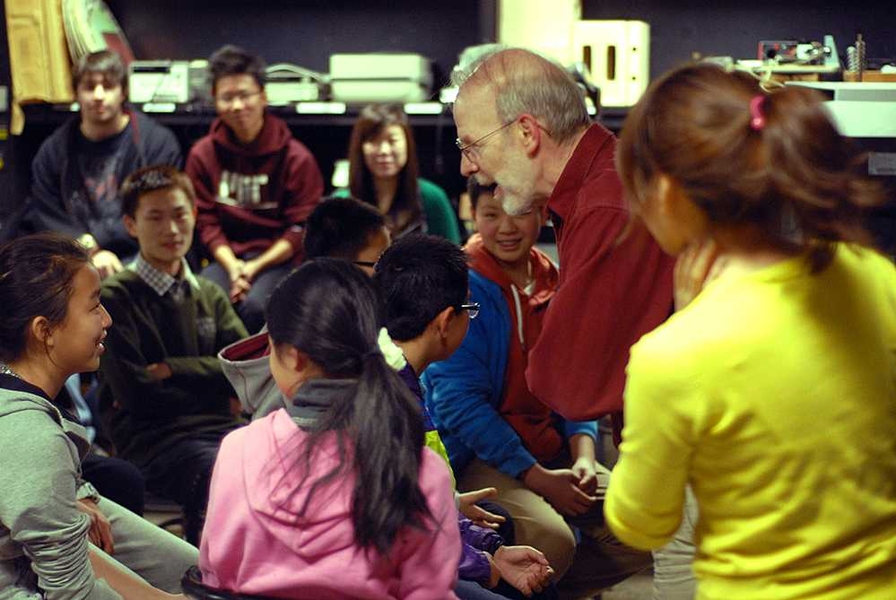 Edgerton instructor Ed Moriarty, center, is surrounded by students during a session.