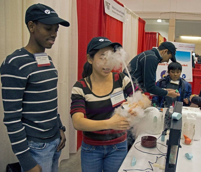 MIT Aero-Astro student Chelsea He prepared a dry ice container to inject vapor into the small wind tunnel, black rectangle at right, to demonstrate how wings work. 