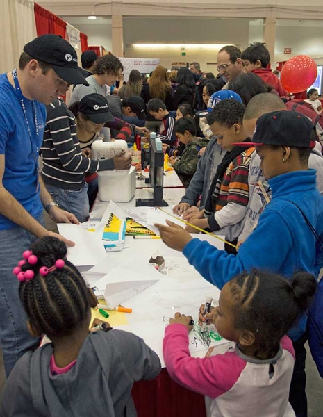 Children at the AAAS Family Days event took part in a variety of activities set up by students from MIT's Aero-Astro department, including making paper airplanes.