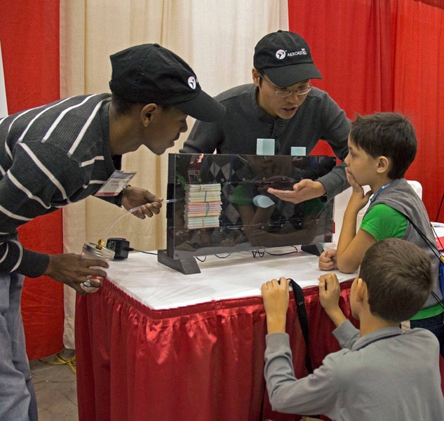 Aero-Astro students Dominique Hoskins (left) and Leo Ng demonstrated how wings work using a miniature wind tunnel.