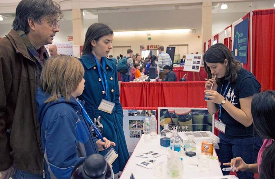 Visitors learned how indicator solutions change color to reveal changes in acidity, by using straws to blow into beakers containing a blue indicator that turns clear when the carbon dioxide in their breath neutralizes the acid solution.