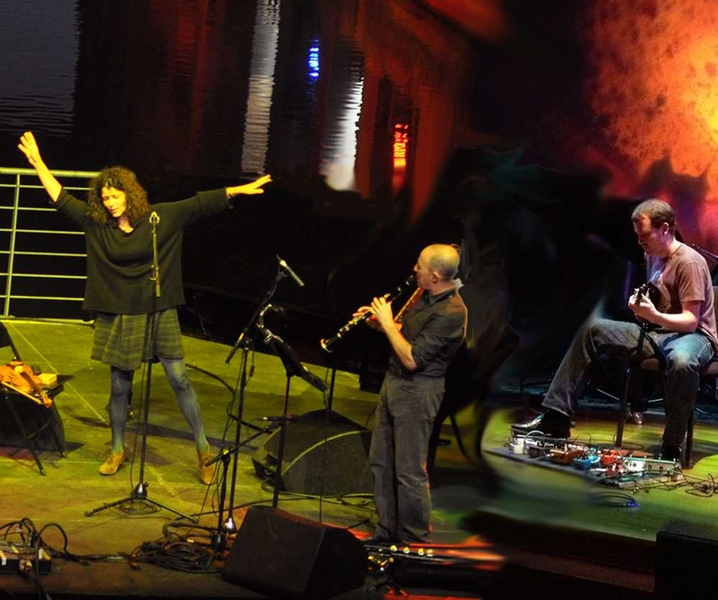 Three performers on stage