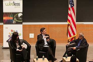 FCC Chairman Julius Genachowski (center) speaks with Professor Dina Katabi and Professor Hari Balakrishnan during the event.