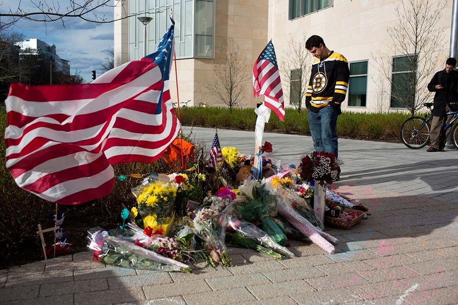 Flags, flowers, teddy bears, notes and more adorn the memorial.