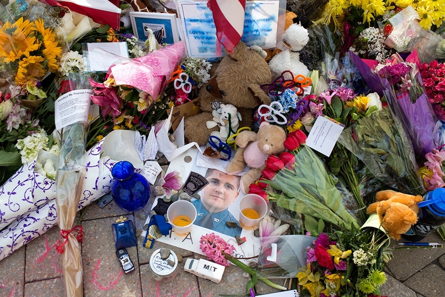 The memorial grew throughout the day Saturday as more community members and visitors left tributes to the fallen officer.
