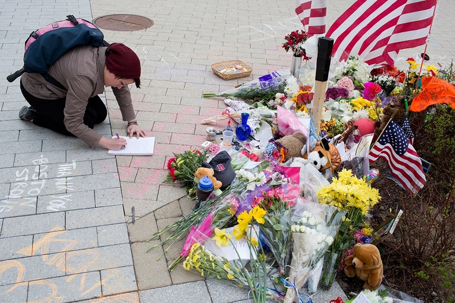 A visitor leaves a notes at the memorial site.