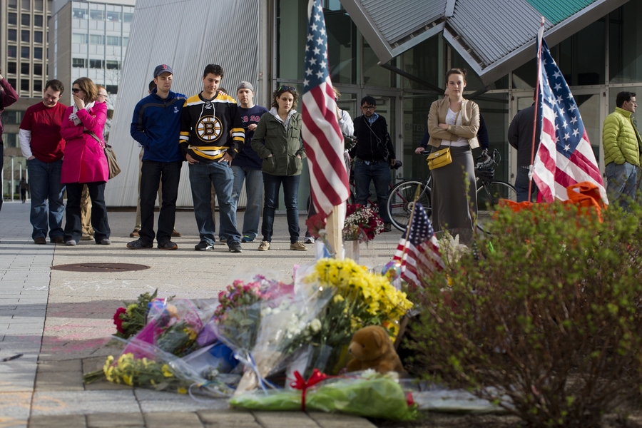 Community members and other visitors gather on Saturday at a makeshift memorial for MIT Police Patrol Officer Sean Collier, who was killed in the line of duty on the evening of Thursday, April 18.