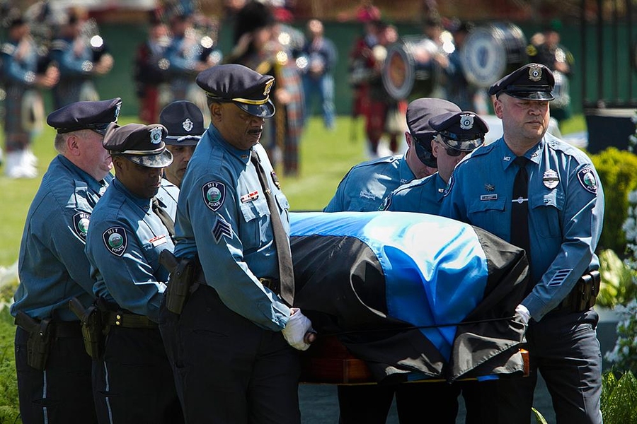Collier's casket was carried out of the memorial ceremony by MIT Police officers.