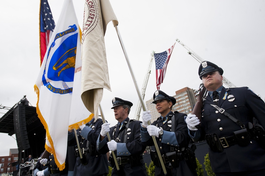 Honor guards from several police departments carried flags onto Briggs Field.