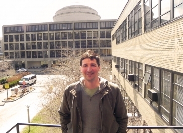MIT Postdoctoral Associate Alvaro Sanchez with the Center for Materials Science and Engineering building (Building 13) and the MIT dome in the background.