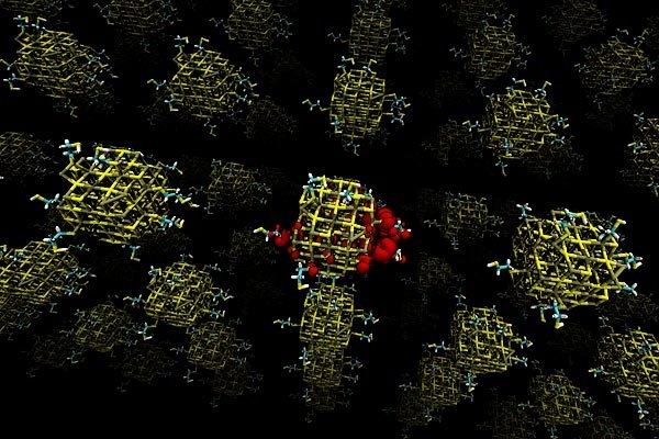 This illustration shows a lead sulfide quantum dot array. Each quantum dot (the colored clusters) is 'passivated' by molecules that bind to its surface. Dots that are made up of unequal amounts of lead and sulfur tend to cause electrons (shown in red) to become highly localized, which can substantially lower the electrical transport of the device.