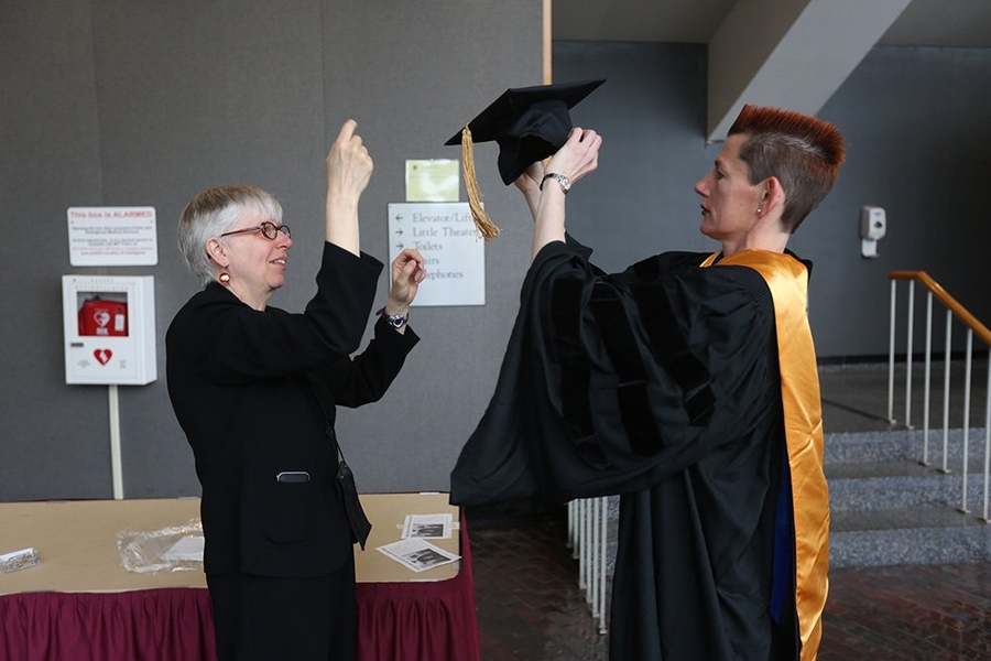 A graduate gets prepared prior to the ceremony.