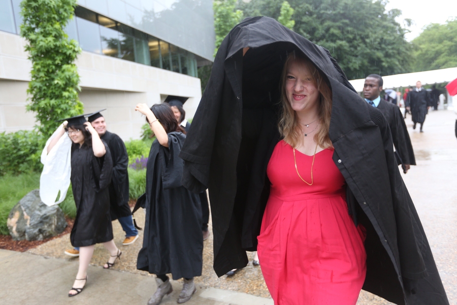 Graduates found novel ways to stay dry before the ceremony.