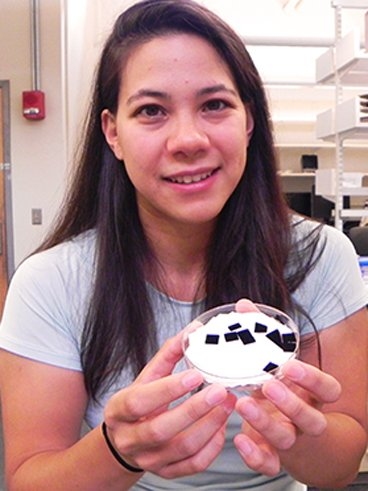 MIT doctoral student Sunny Wicks holds samples of carbon nanotube-strengthened cloth.