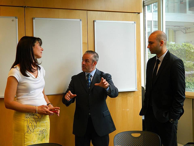 Massachusetts Secretary of Education Matthew Malone (center) speaks with Natalie Kuldell (left) — instructor in the Department of Biological Engineering and founder of BioBuilder — and Ryan Mudawar of Massachusetts Life Sciences Center.