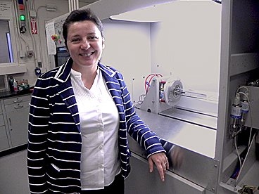 Associate Professor Silvija Gradečak with a metal organic chemical vapor deposition system used to create nanowires from metal seed particles.