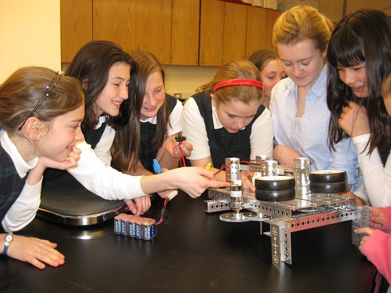 Young (second from right) mentors FIRST all-girls robotics teams.