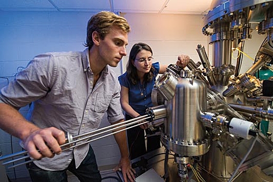 Graduate student F. William Herbert (left) and Associate Professor Bilge Yildiz prepare to study a sample using a scanning tunelling microscope.