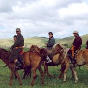 Professor Buyandelger (center) riding in the Mongolia steppe with nomadic shaman