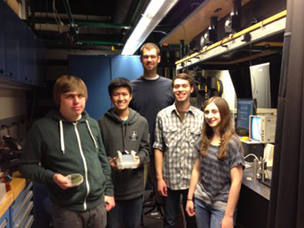 Chemistry graduate student Jeffrey K. Eliason (standing, at back) with Swampscott High School students (from left), Andrew James, Kenny Li, Noah Gopen, and Alexa Beatrice in the lab for Lambda Project work.