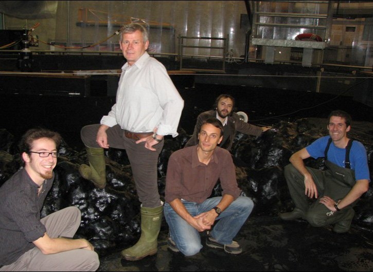 (From left to right) Matthieu Mercier, Henri Didelle, Samuel Viboud, Louis Gostiaux, and Thomas Peacock inside the 50-foot rotating tank used for their tests, with a replica of the seafloor topography of the South China Sea inside it.