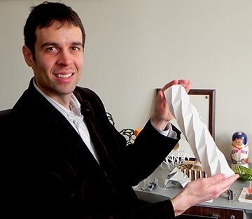 Professor A. John Hart with a folding paper cylinder. Paper's ability to fold and unfold many times and retain its integrity is a motivation for Hart's work on origami-inspired engineering.