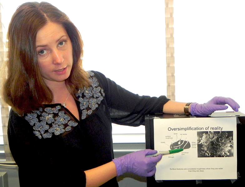 MIT postdoc associate Taisiya Skorina explains how surface roughness, a combination of pores and cavities in particles of finely ground feldspar, helps promote release potassium for fertilizer. She has developed a process to chemically alter feldspar to produce a new compound ­– coined "hydrosyenite" – with a popcorn-like texture.