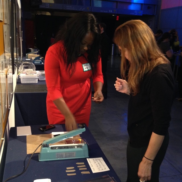 D-Lab's Nai Kalema assists a workshop participant heat-seal her inflatable light.