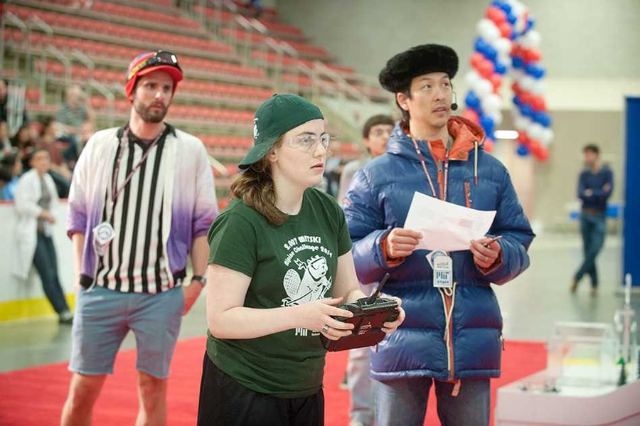 Student Emma Steinhardt guides one of her two robots using a remote control system, as associate professor of mechanical engineering Sangbae Kim (right) looks on.
