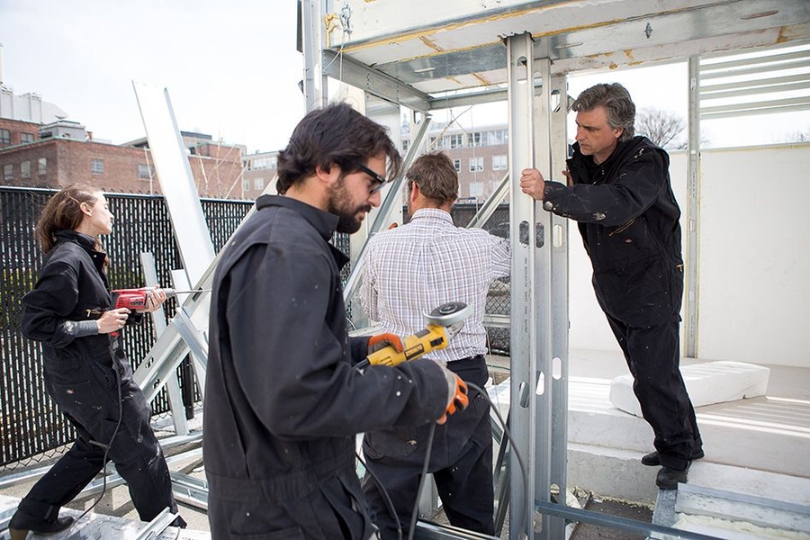 Mesa (left) and Garcia-Abril (right) with colleagues in their outdoor workshop
