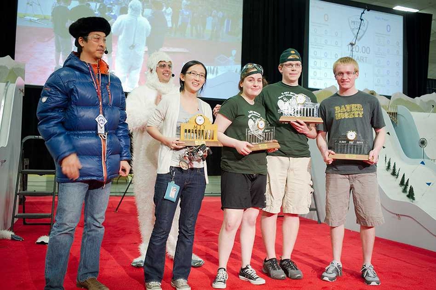 Class co-teachers Sangbae Kim and Amos Winter celebrate with top winners of the competition displaying their trophies. From left, the students are Clare Zhang (first place), Emma Steinhardt (fourth place), Joshua Born (second place), and Jacob Wachlin (third place, and high-scorer in the contest).