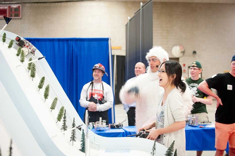 Clare Zhang, a junior majoring in mechanical engineering, controls her robot on its way to final victory in the competition. She is watched by Amos Winter, assistant professor of mechanical engineering and co-teacher of the class, who wore a Yeti costume in keeping with the mountain theme.