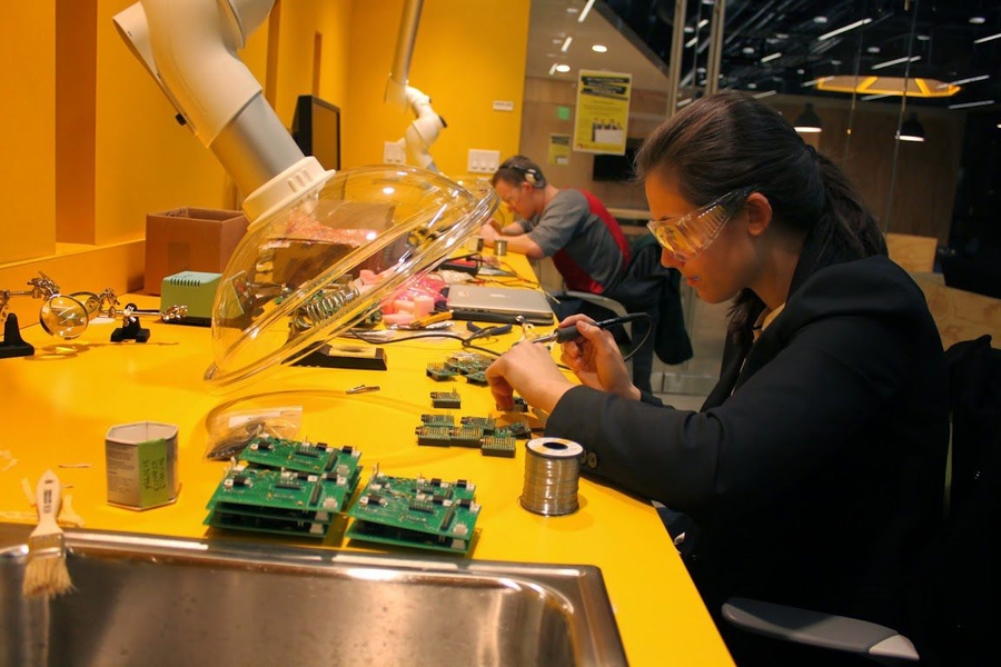 Katie Spies works on the internal wiring on a CLAIRITY node. 