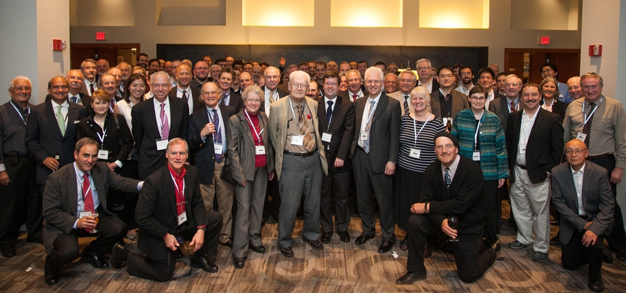 Large group of people stand posing for photo