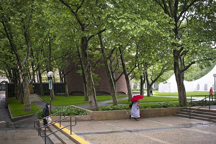 Today's weather required umbrellas and ponchos to protect academic regalia.
