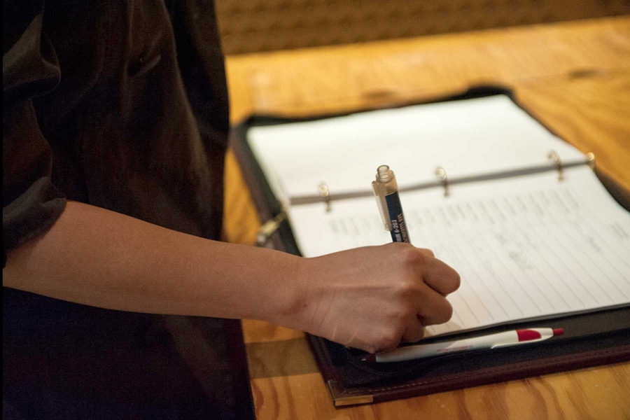 Inductees sign the official register of Xi of Massachusetts before receiving their official certificate of membership.