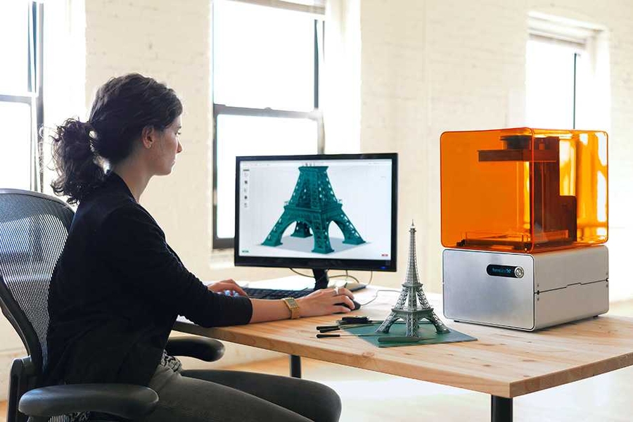 A user works away on Formlabs' Form 1 3-D printer and PreForm software