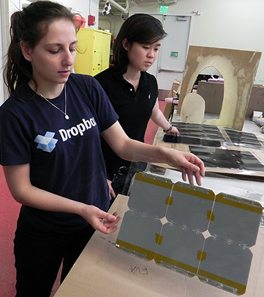 Abramson and Chao look over solar cells for “Valkyrie." The students take bare monocrystalline silicon solar cells from SunPower and make their own protective sheathing for the cells, says Abramson, who is electrical lead for the team.