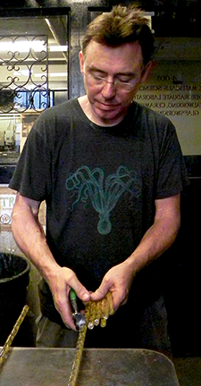 MIT Glass Lab Director Peter Houk snips glass cane for a project. The Glass Lab will close in June for renovations and reopen in December.